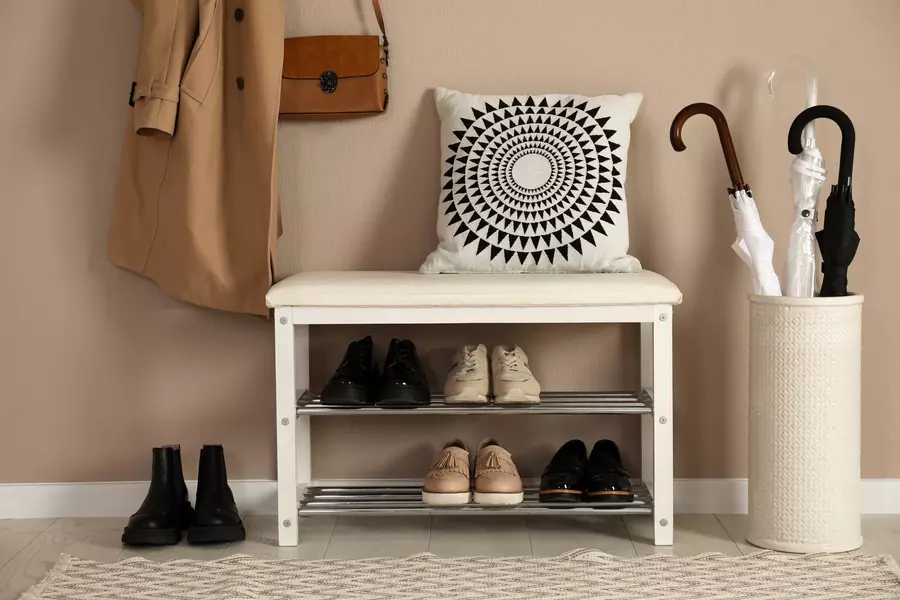 A small shoe rack by the door in a modern home