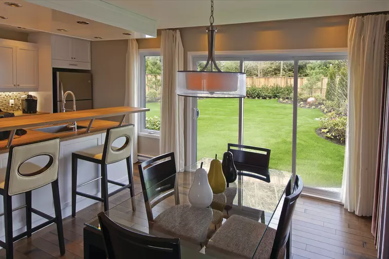 3-panel sliding patio door with dining room of a home shown.