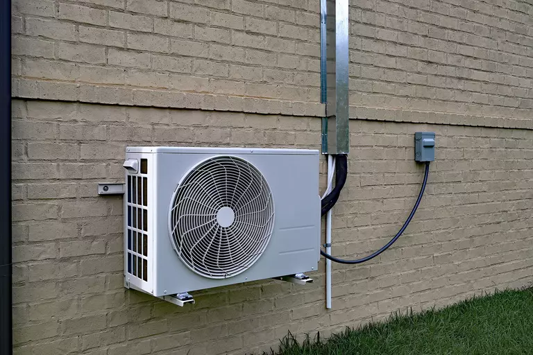 Ductless mini-split cooling system on a wall.