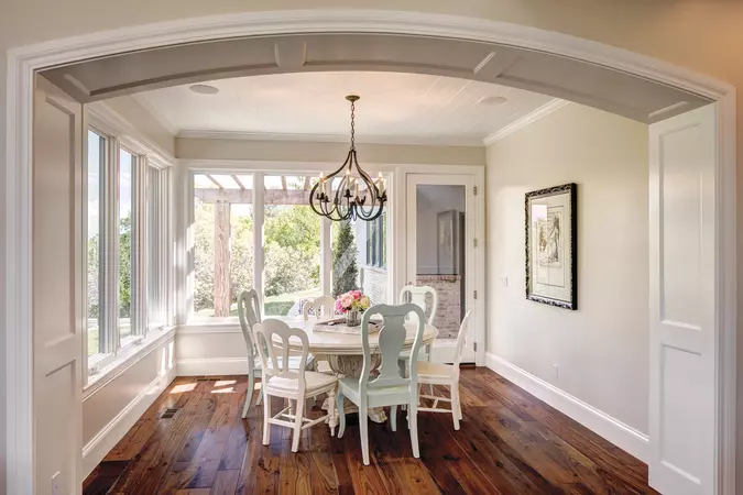 White interior wood-clad casement & awning windows in a dinning room with a white table