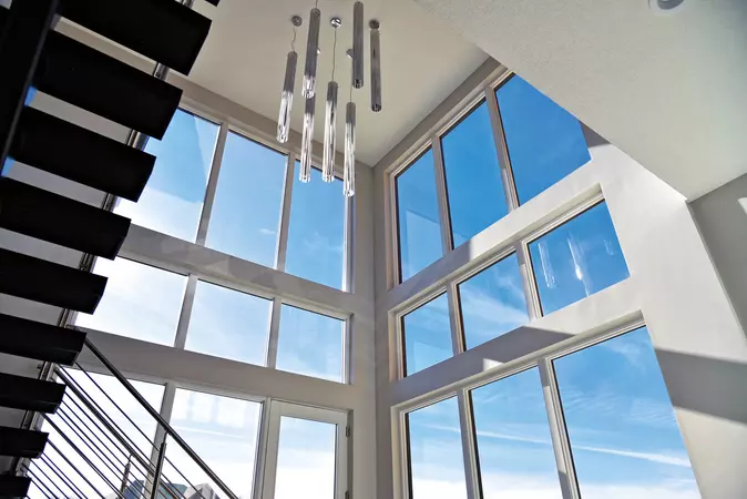Several wood-clad low profile direct set windows in a foyer letting an abundance of natural light in