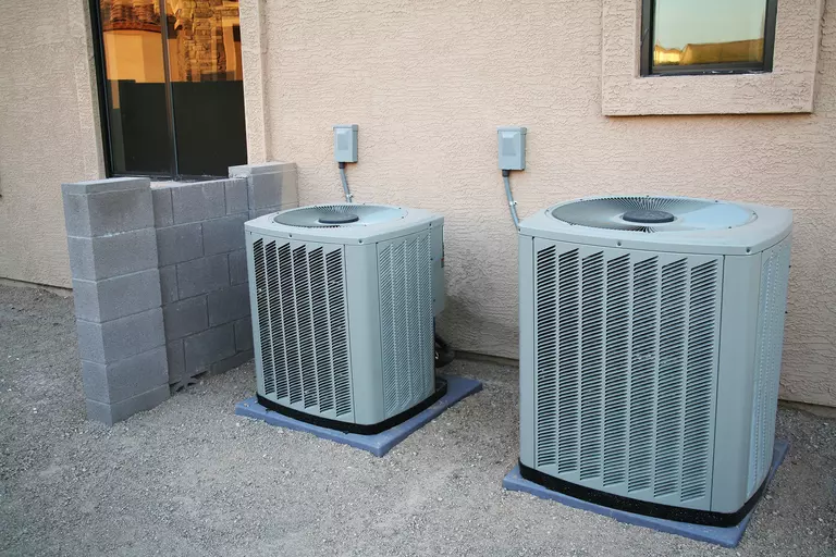 Two central AC home cooling units.