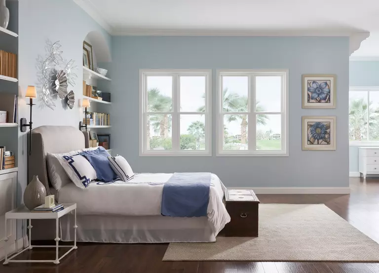 Bedroom with custom coastal windows used to get fresh air into the room.