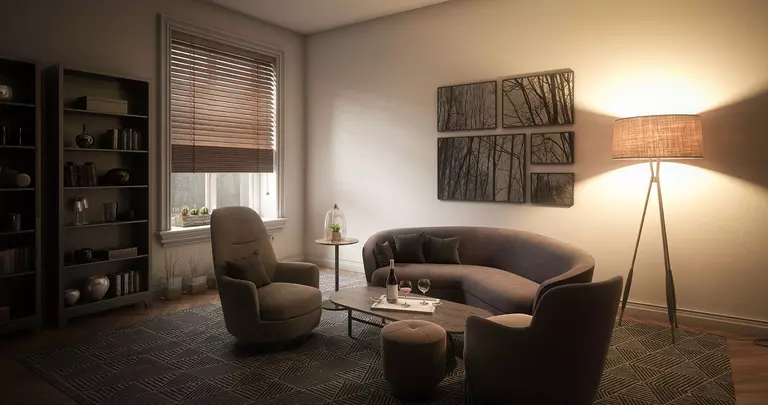 A modern living room with a lamp in the corner. The blinds are drawn to help keep the summer heat out. 