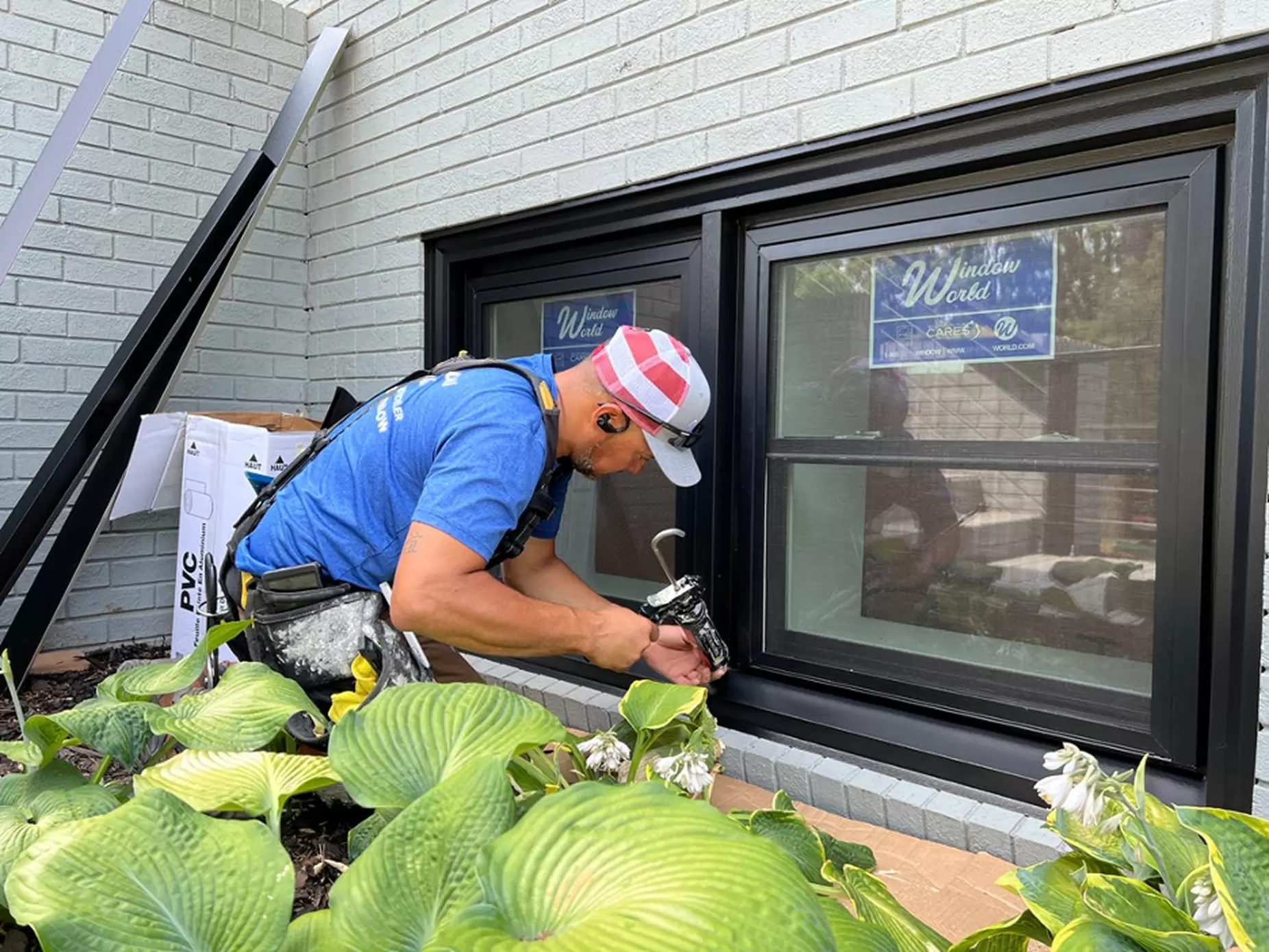 Window world professional sealing the edges of new windows.