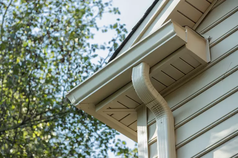 Corner of a gutter system on the second story of a home.