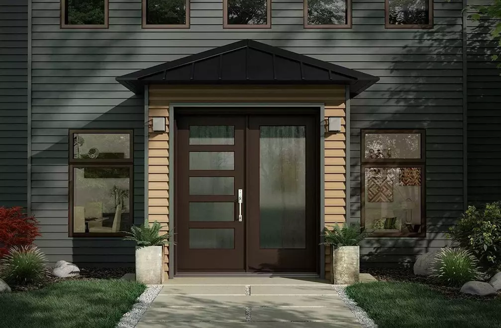 Exterior view of a home with replacement siding and windows 