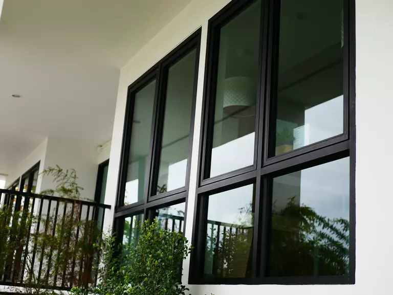 Black aluminum windows on the exterior of a home.