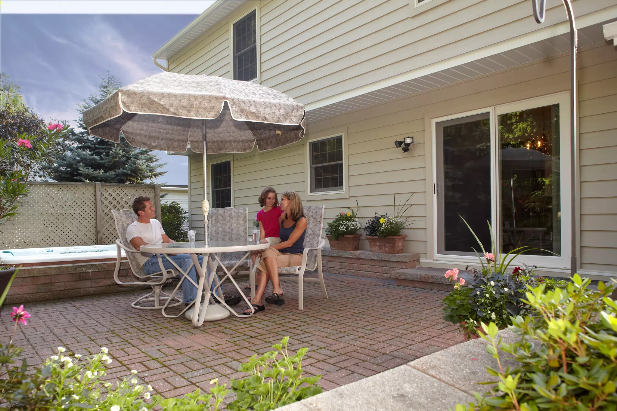 Family seated at a back patio table.