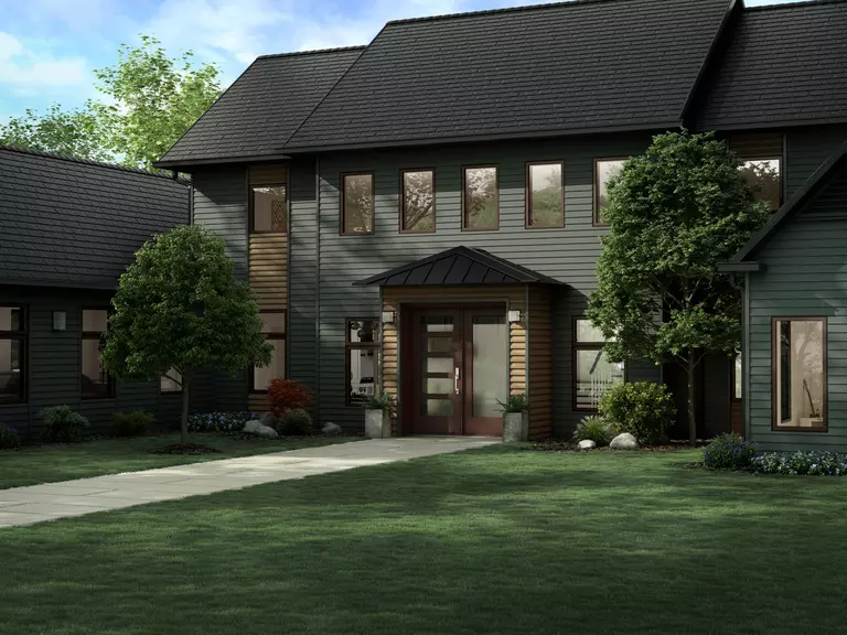 The front of a home with dark vinyl siding and dark accents.
