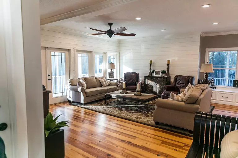 Living room with wood flooring and cozy furniture.