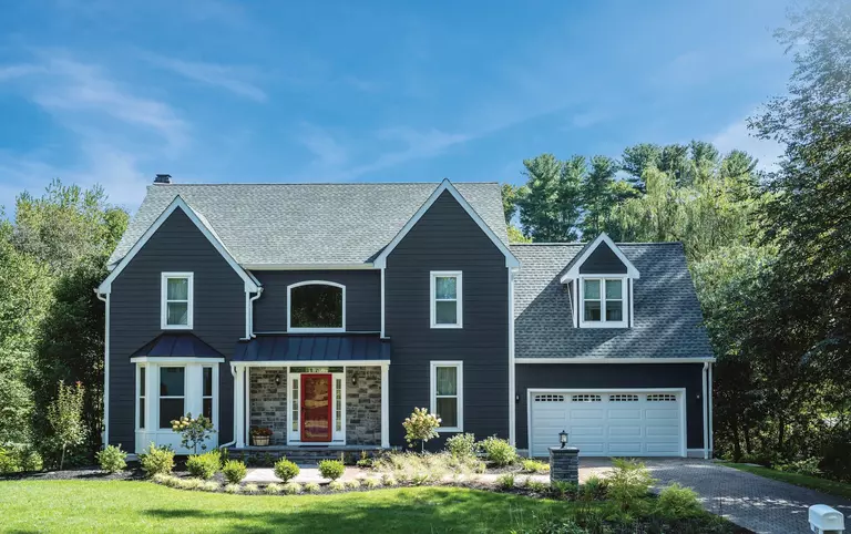 ASCEND composite cladding siding on a home with a red entry door.