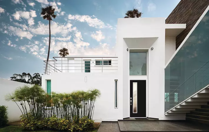 Black modern entry door with 1 vertical lite on a coastal home.