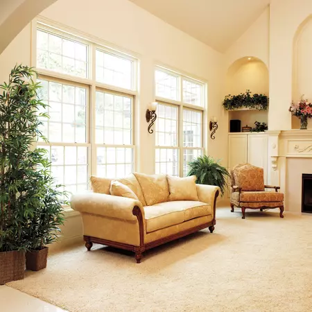 White interior wood-clad double-hung windows in a living room with a vaulted ceiling