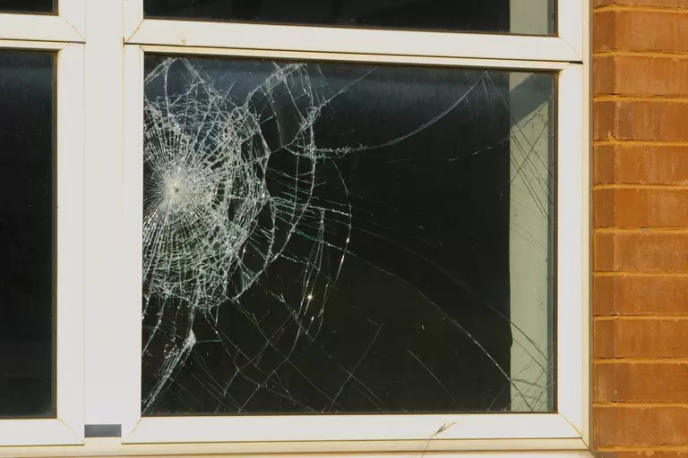 Window pane with broken glass from an impact.