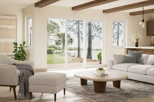 A coastal home with a white window world sliding patio door and casement windows