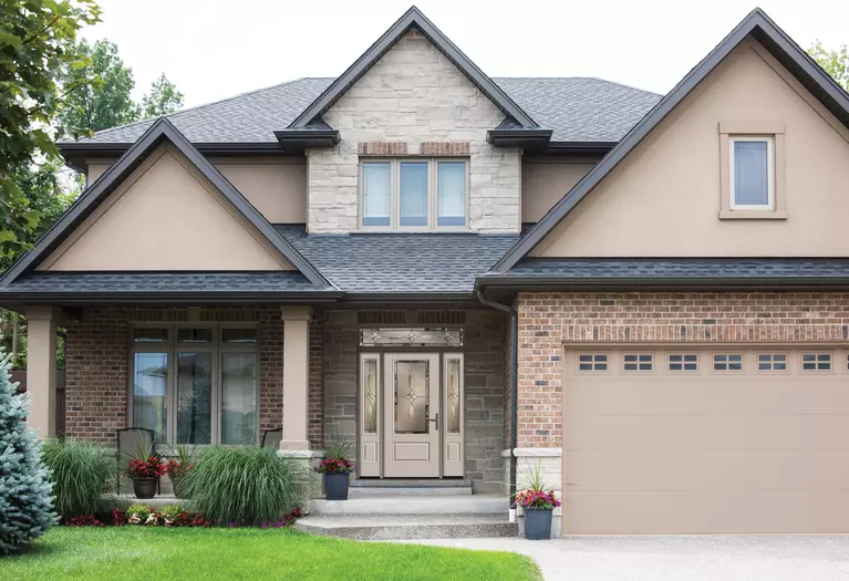 The front of a home with brick and dark exterior accents.