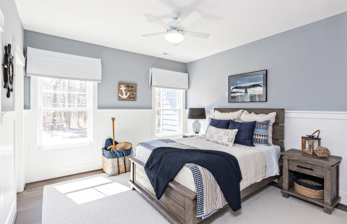Bedroom with a bed in front of window.