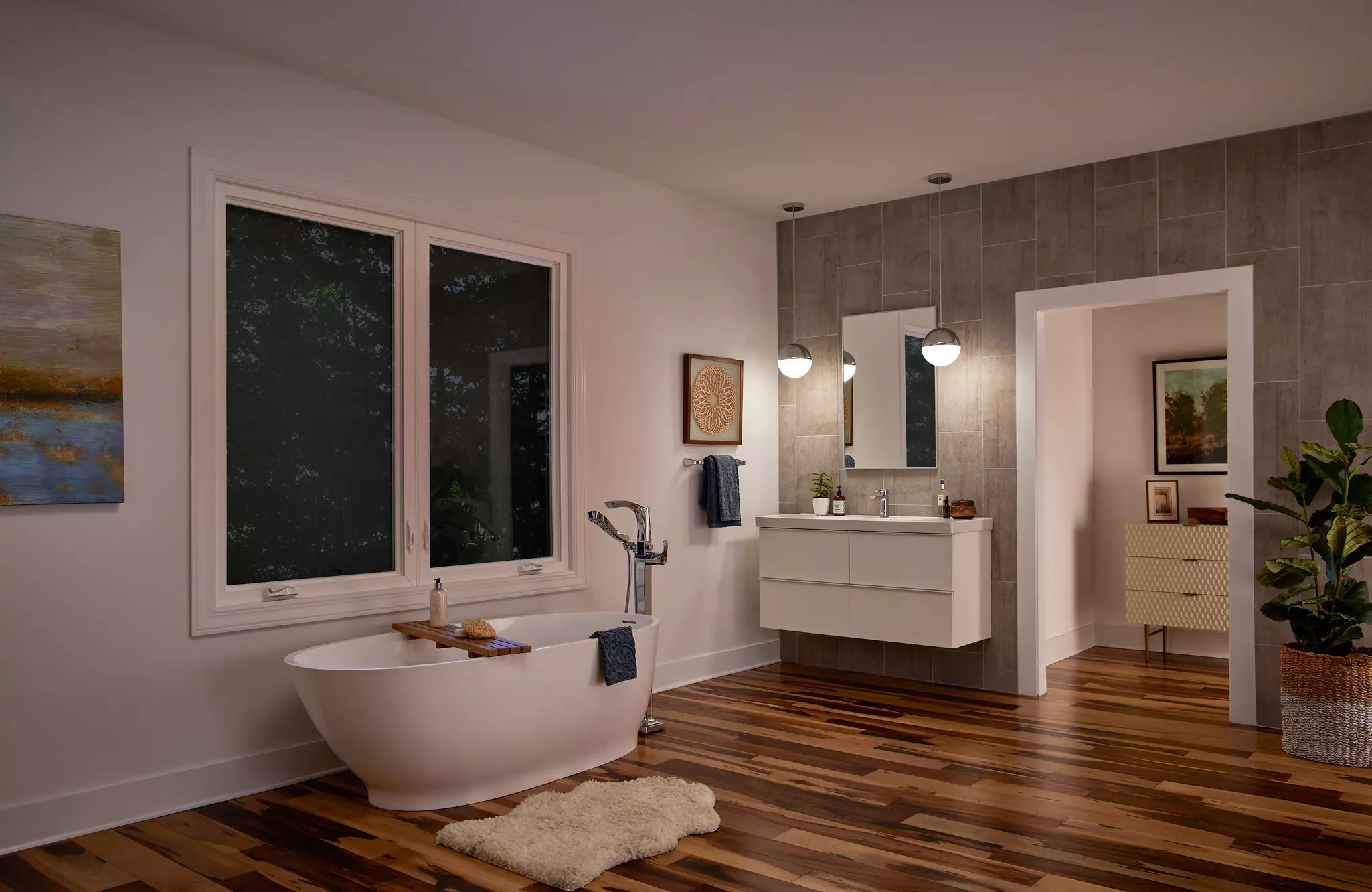 Home bathroom in the evening with dusk outside of two casement windows.