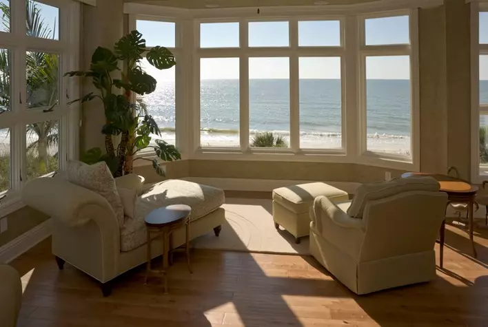 Outside patio of a home with beach house windows and patio door