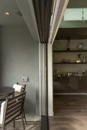A side view of a multi-slide patio door fully concealed in a wall pocket.