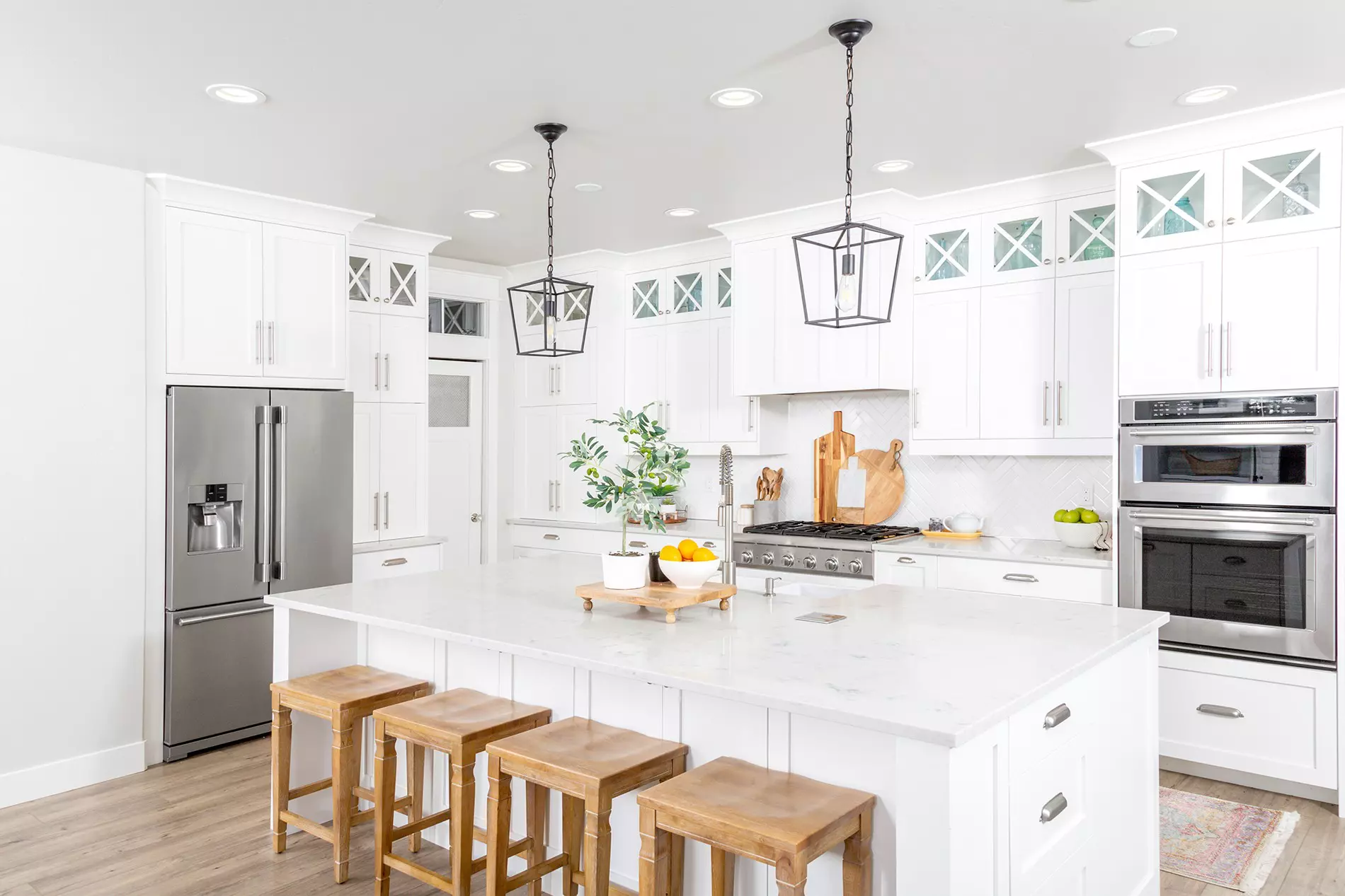 Beautiful white kitchen island with seating space and pendant lighting