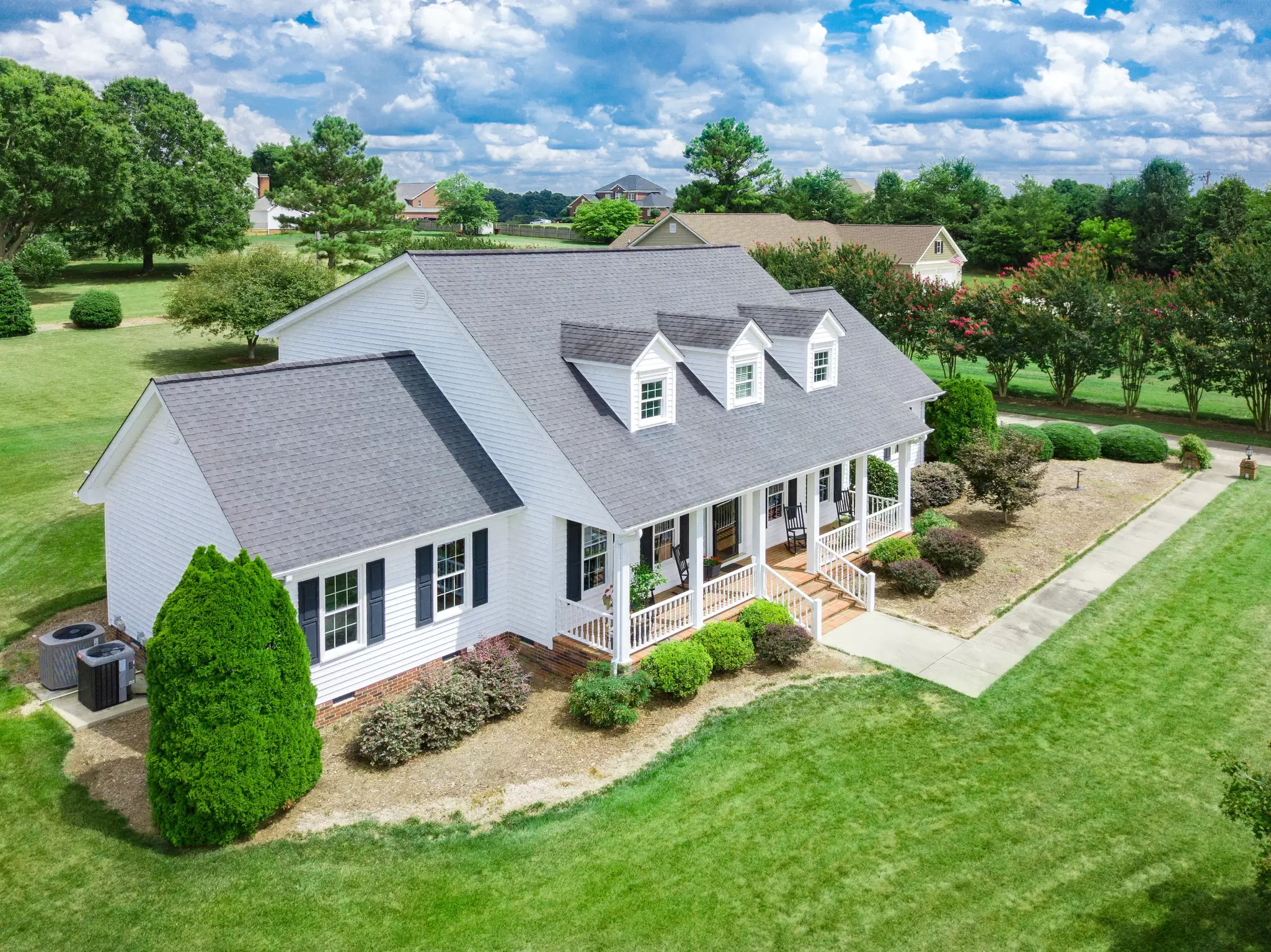 Aerial view of a residential home with dormers.
