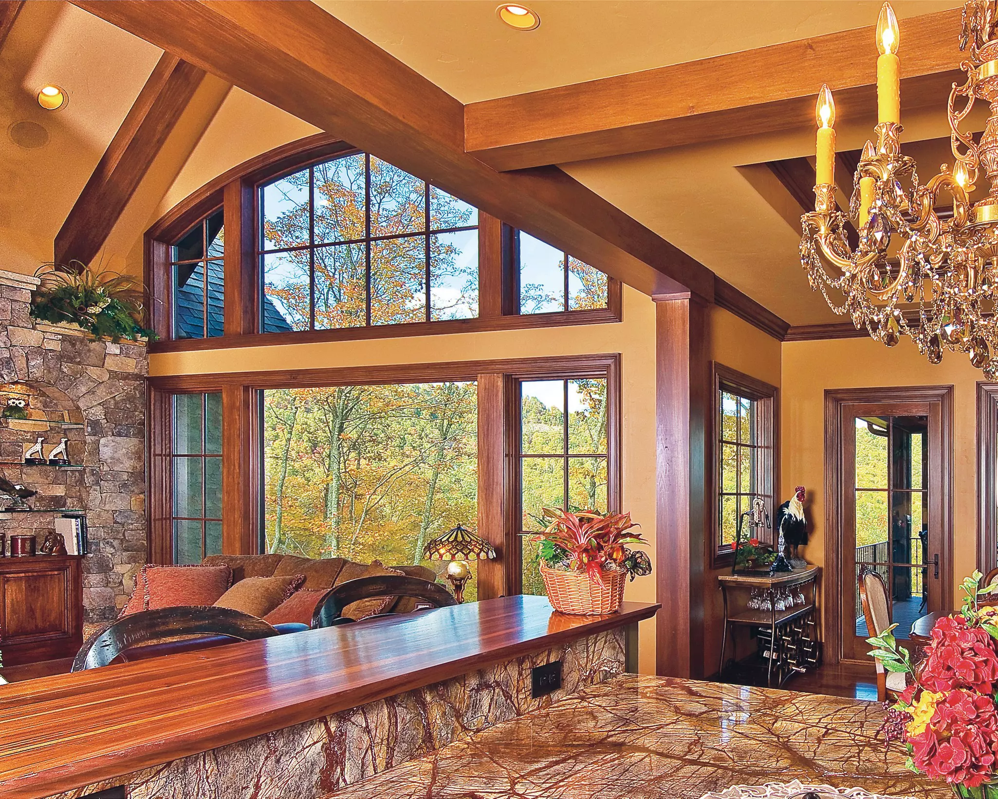 Interior of a home living area with a combination of wood-clad window shapes.