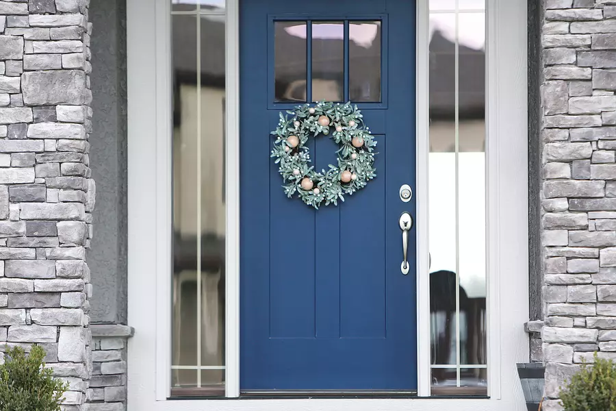 Holiday wreath on a blue front entry door 