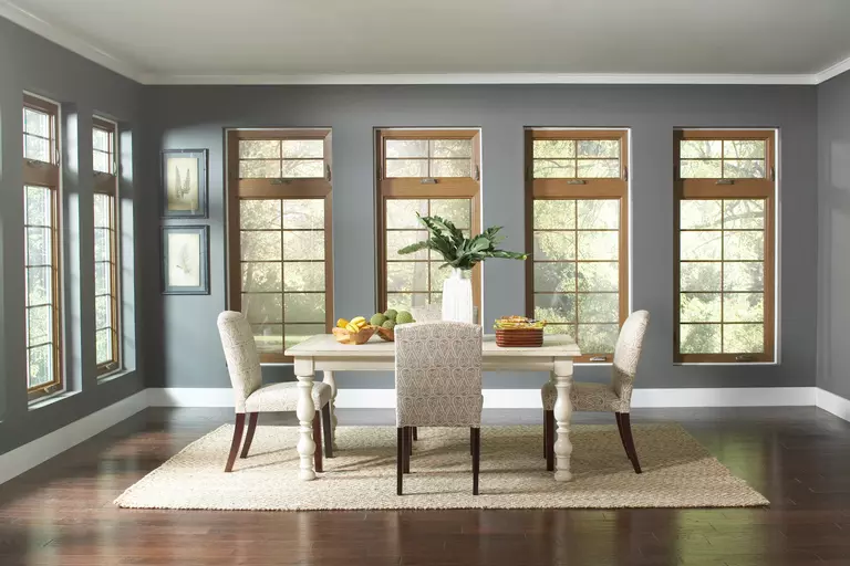 Decorated dining room with six energy-efficient windows.