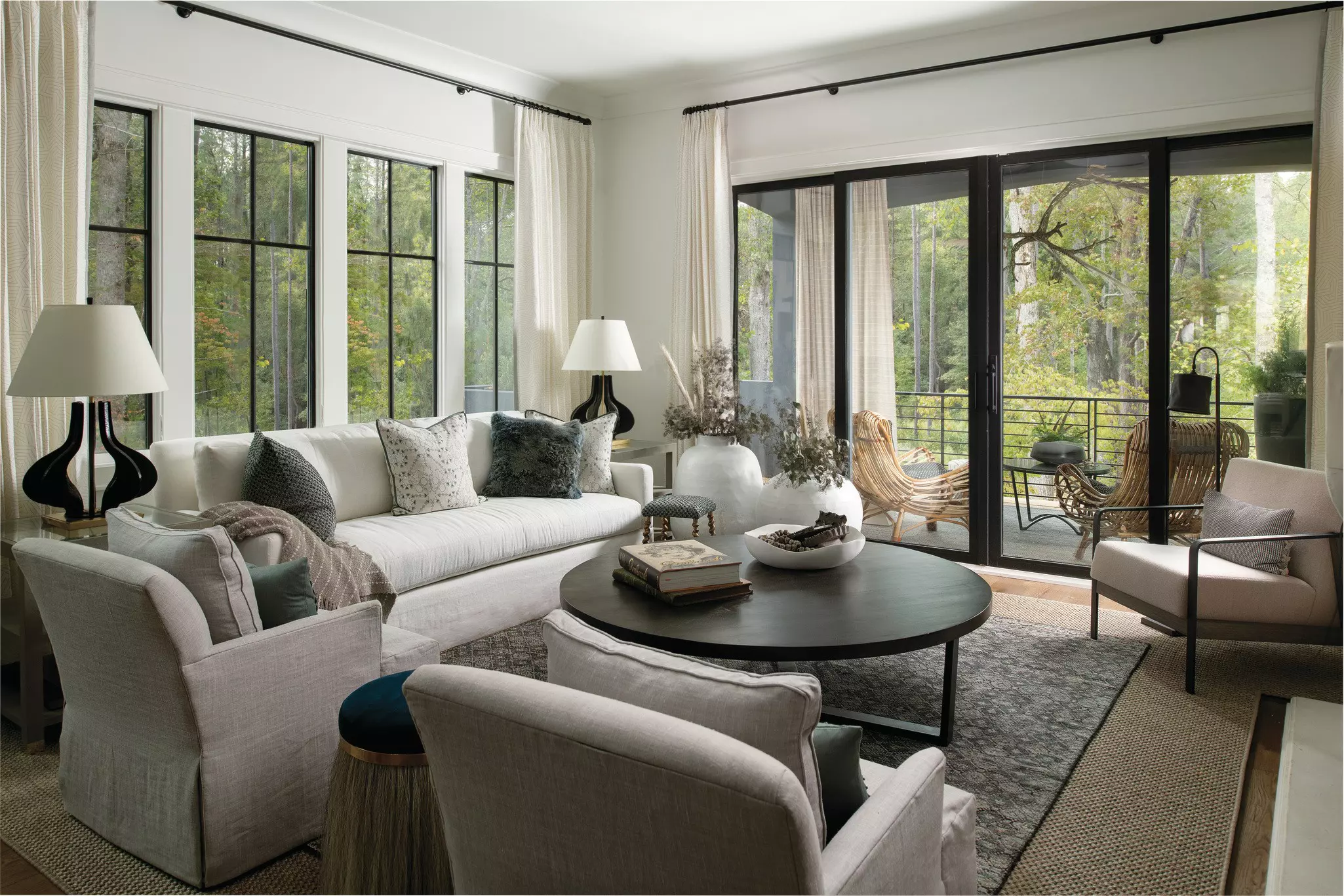 Black sliding patio door with living room interior shown featuring a couch, chairs, and table.