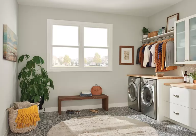 Laundry room inside a home with large double-hung windows.