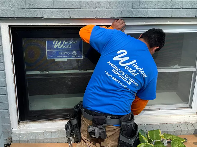 Window World professional installing a new window on a home.