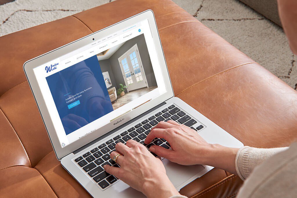 Person looking at the Window World website on a laptop