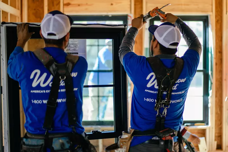 Window World installation professionals preparing a double-hung window.