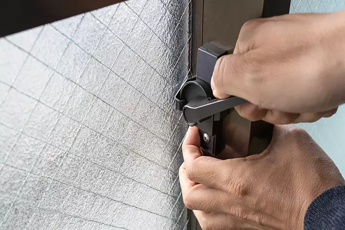 Hands Checking Window Locks