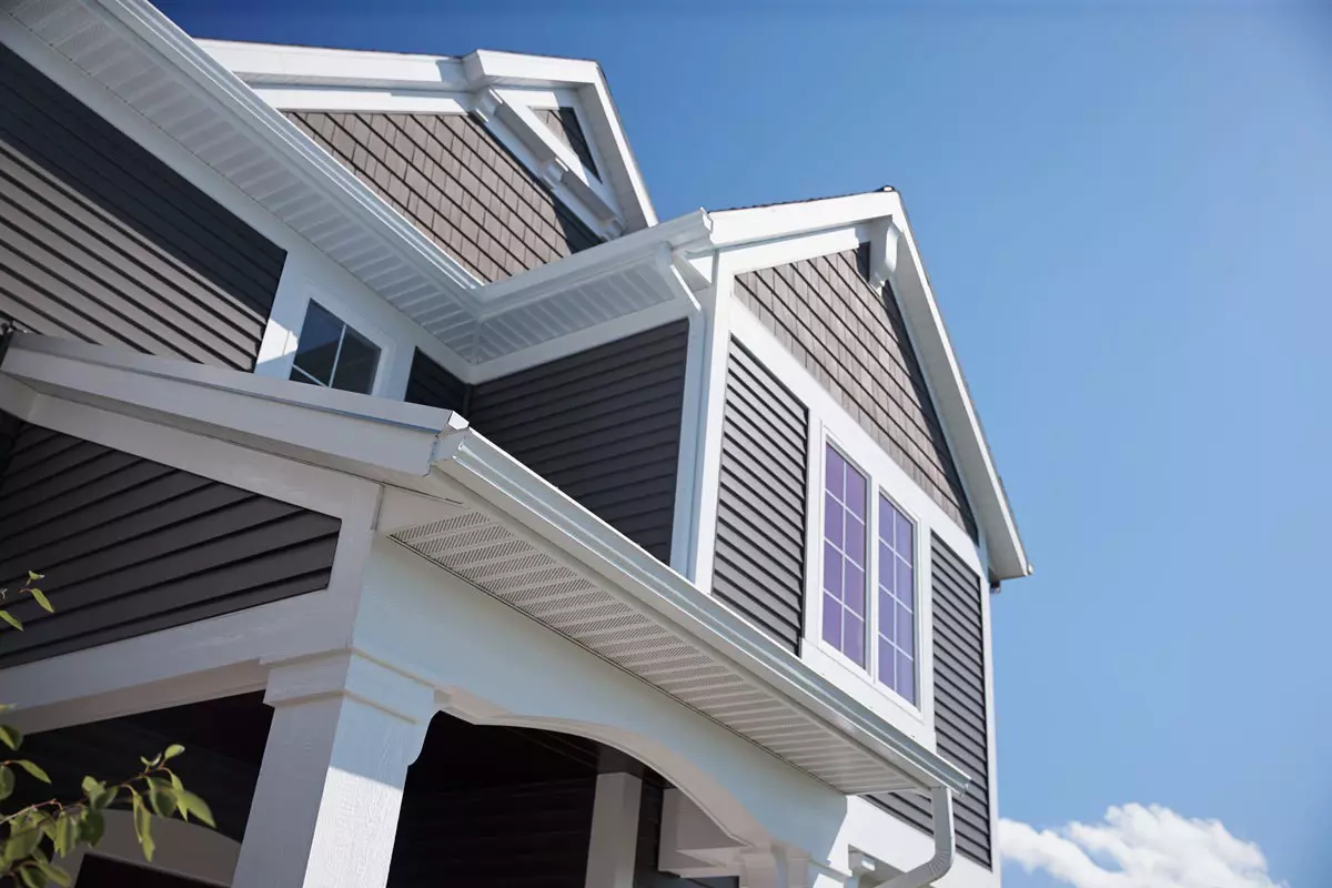 Upper story of a home with gray siding.