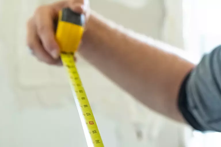 Close-up of an extended yellow tape measure.