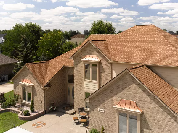 2 story brick home with the CertainTeed's Landmark shingle line in the color Resawn Shake.