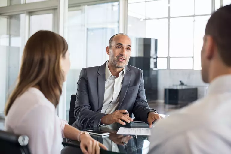 Man and woman sitting down with a HELOC loan consultant.