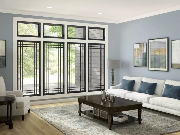 A living room with large windows and grey walls.