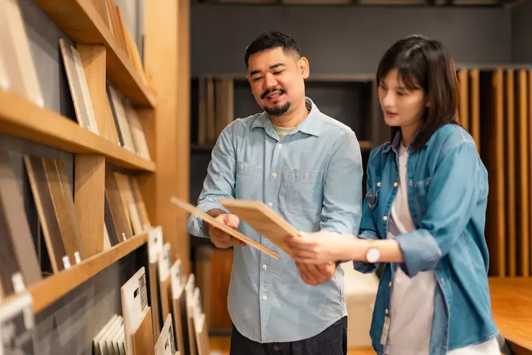 Couple surveying different building materials.