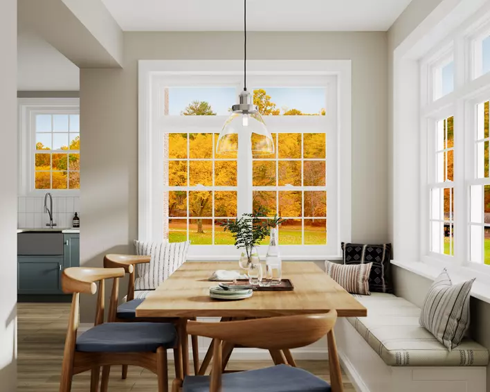 An upscale dining nook pictured in Autumn, with yellow leaves visible on trees through a set of Low-E windows. 