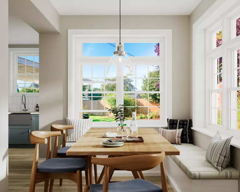 Interior of a home with a dining table and a combination of window styles with grids.
