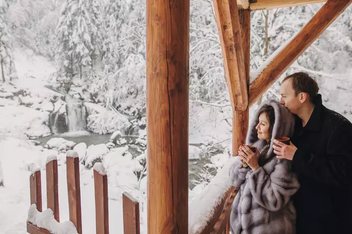 Couple on snowy porch
