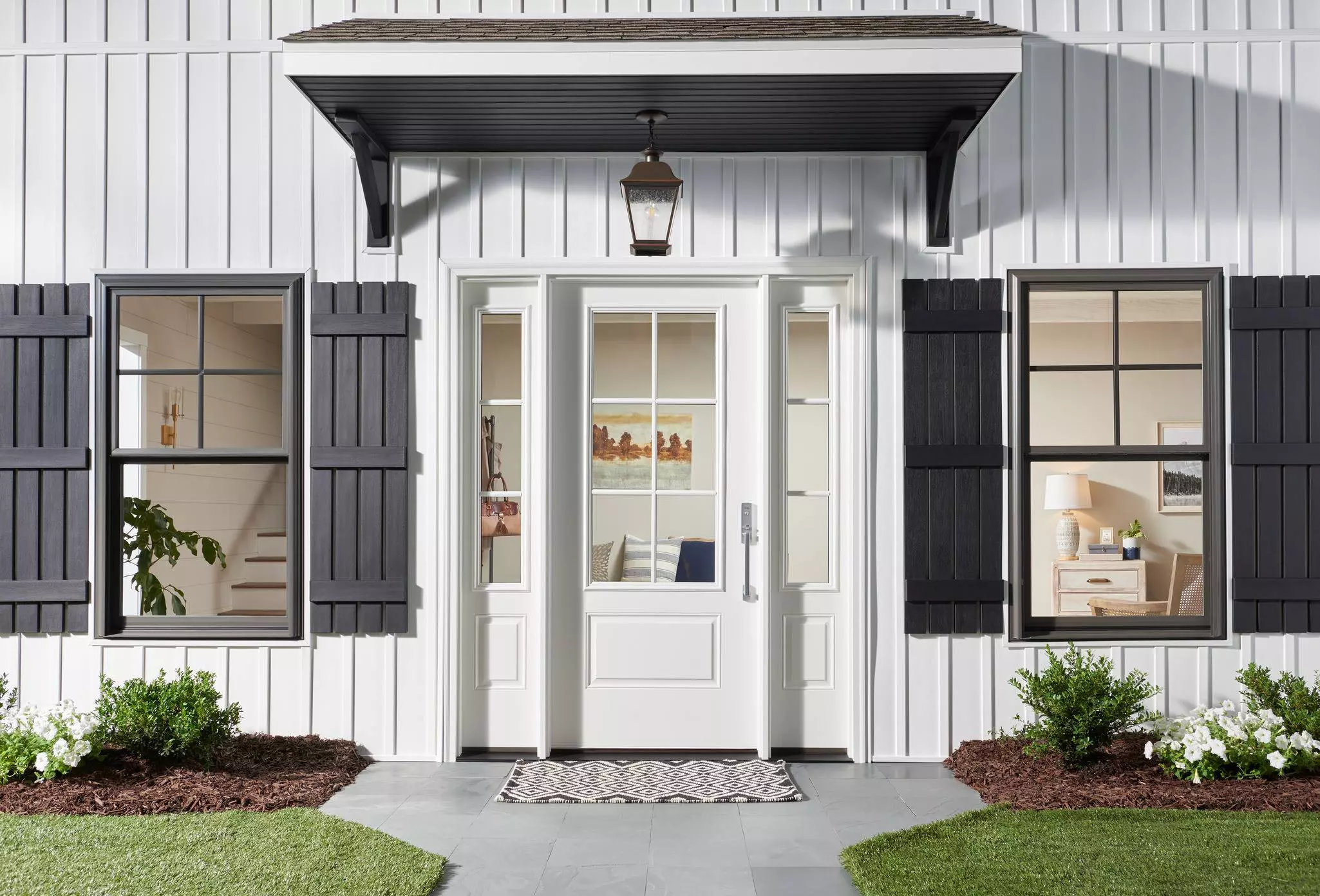 Front of a home with a white entry door and sidelites with window grids.