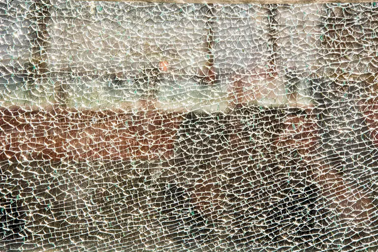 Close-up of broken tempered glass.