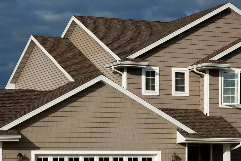 Upper level of a home with a tan exterior.