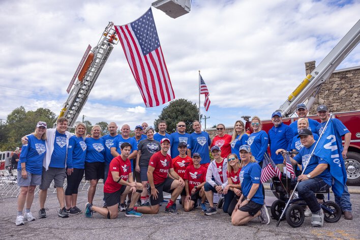 Group of Window World employees in front of an American flag. 