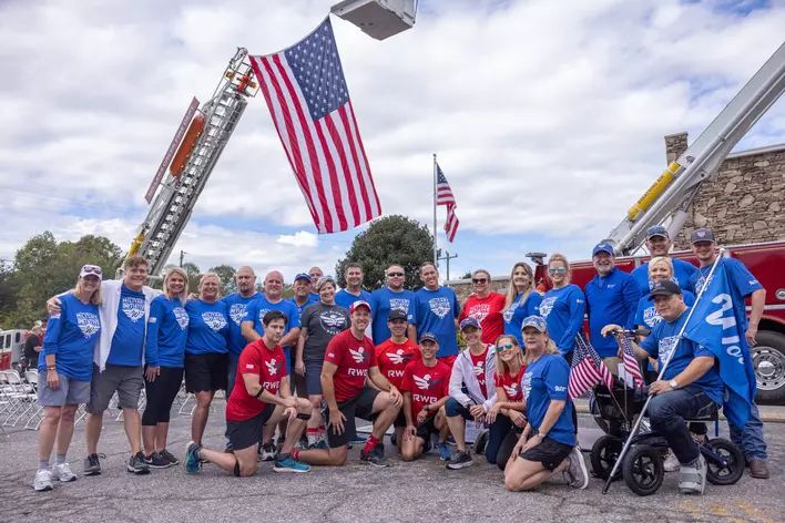 Group of Window World employees in front of an American flag. 